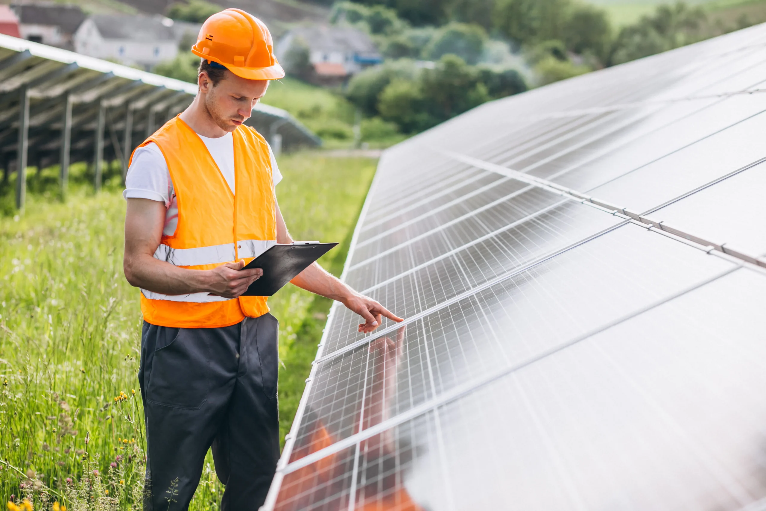 Solar worker inspecting a field of solar panels
